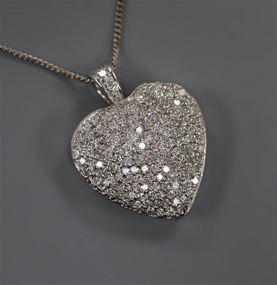 A modern pierced white metal and pave set diamond heart shaped pendant on an 18ct white gold fine link chain, pendant overall 3cm.